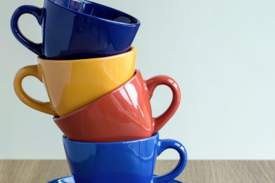 stack of colorful coffee cups on table